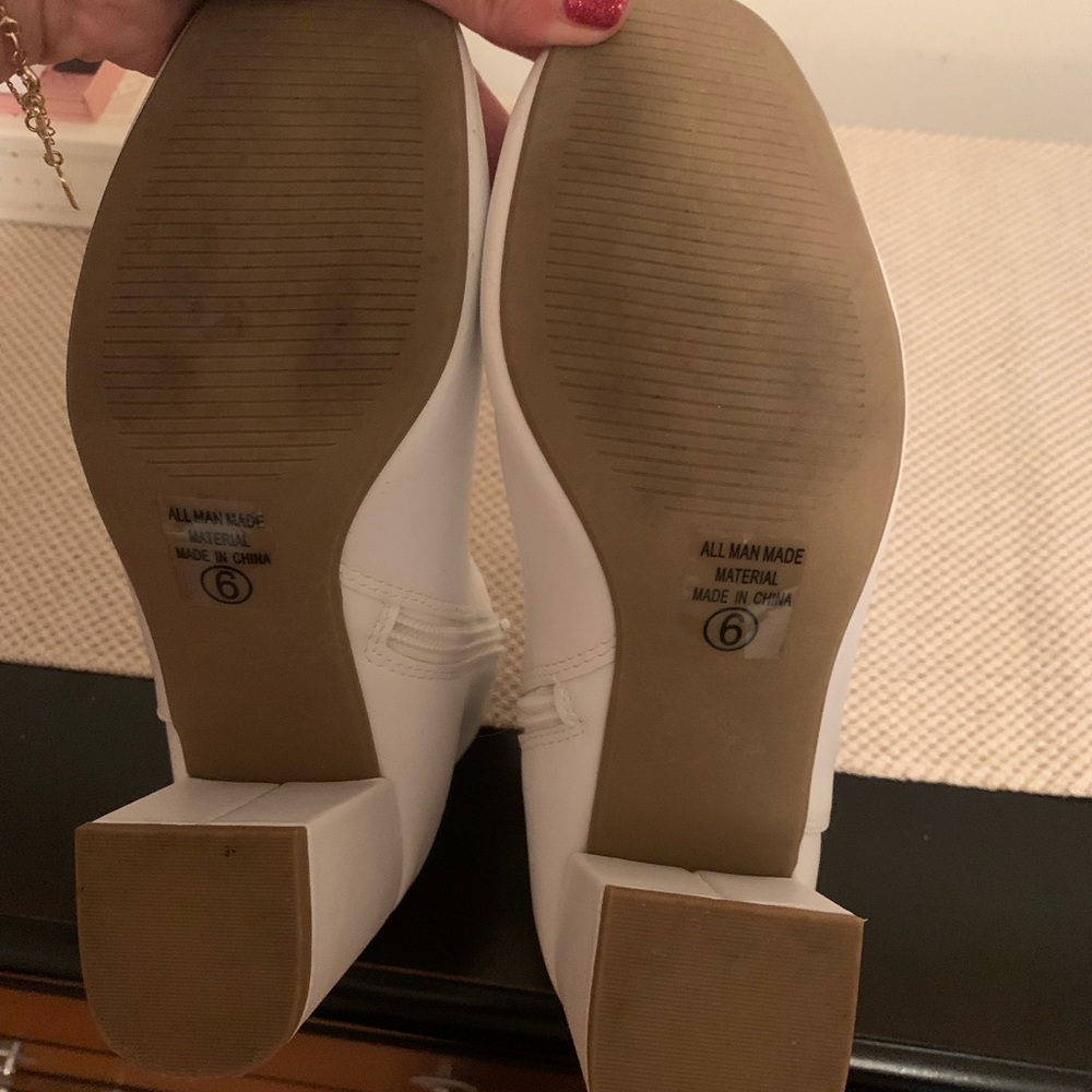 White boots. Lightly worn and creased.